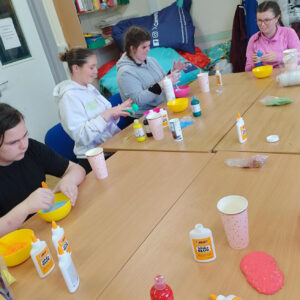 A group of young people around a table creating crafts